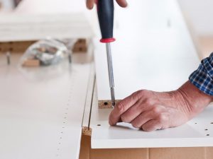 Photo of man assembling furniture 